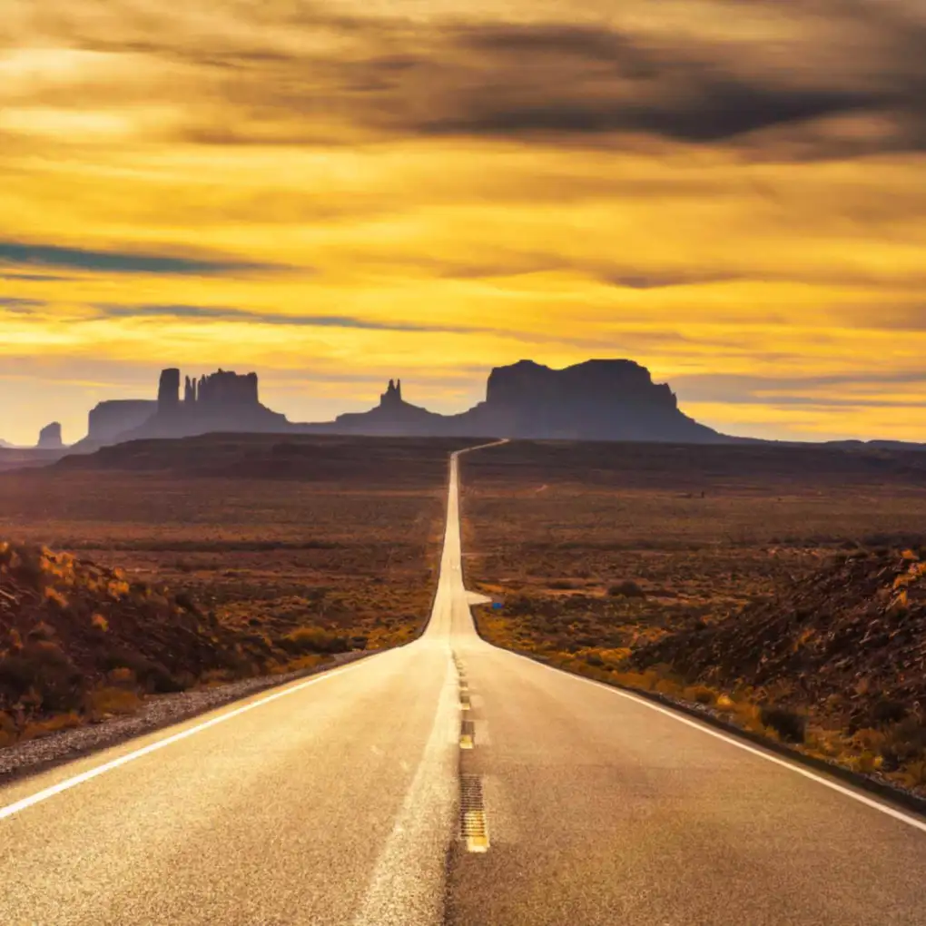 A highway stretches through Monument Valley, Utah